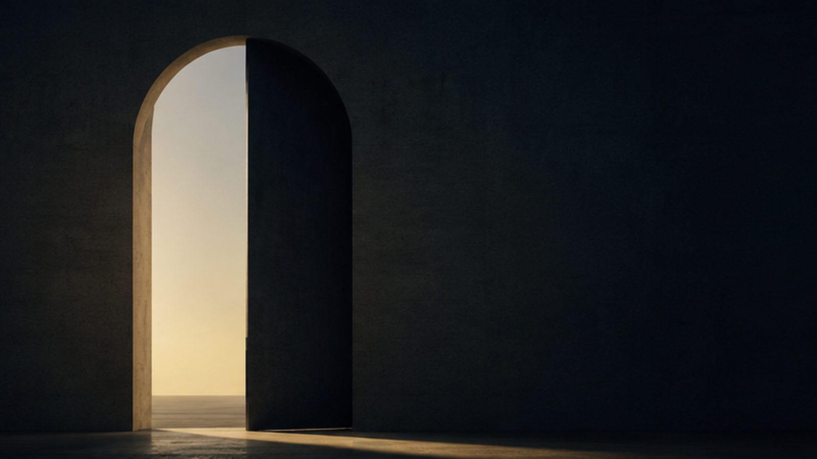 An open door in a dark wall, light coming through